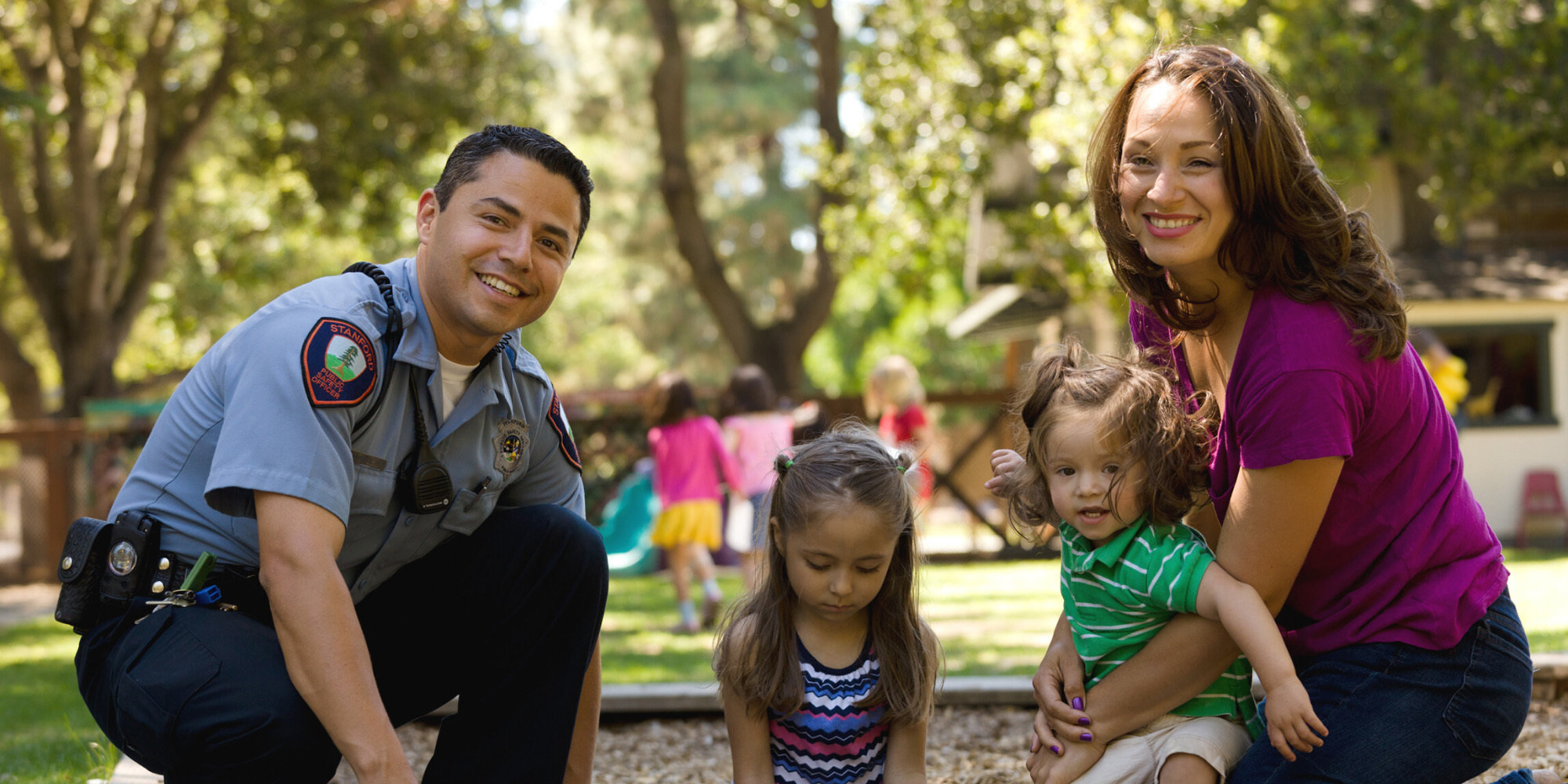 Couple with their two kids in a sandbox